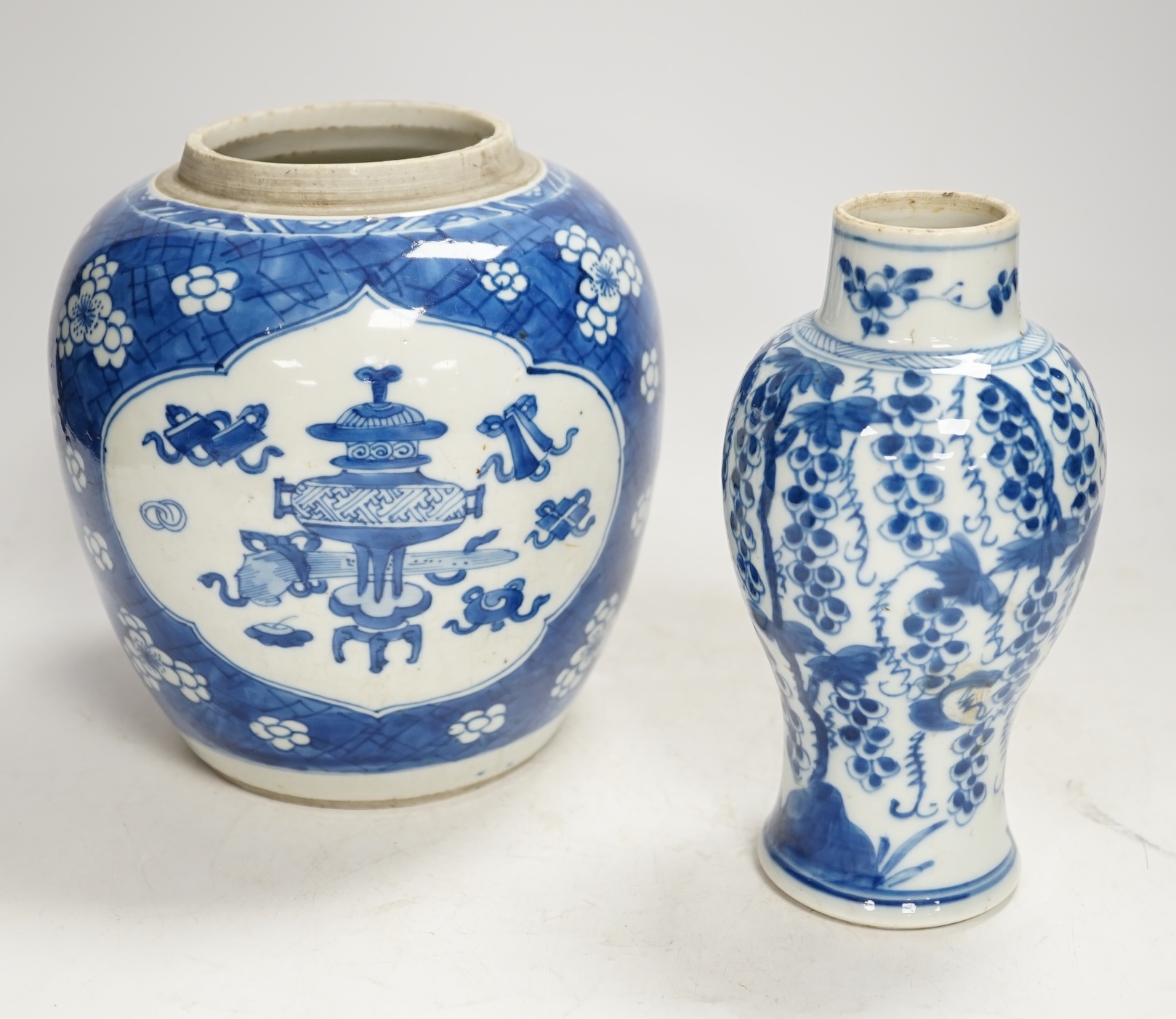 A Chinese Kangxi blue and white jar and a similar vase, jar 19.5cm high. Condition - both cracked and chipped, poor
